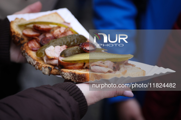 Traditional loaf of bread with lard and topping at Christmas market at the Main Square in Krakow, Poland on Nobember 30th, 2024.  