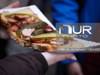 Traditional loaf of bread with lard and topping at Christmas market at the Main Square in Krakow, Poland on Nobember 30th, 2024.  (