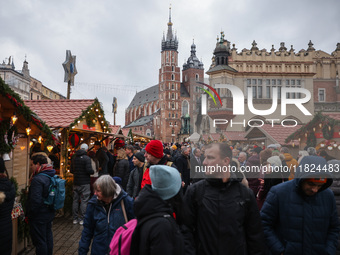 Touriststs visit traditional Christmas market at the Main Square in Krakow, Poland on Nobember 30th, 2024.  (