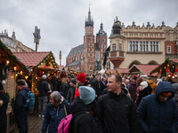 Touriststs visit traditional Christmas market at the Main Square in Krakow, Poland on Nobember 30th, 2024.  (