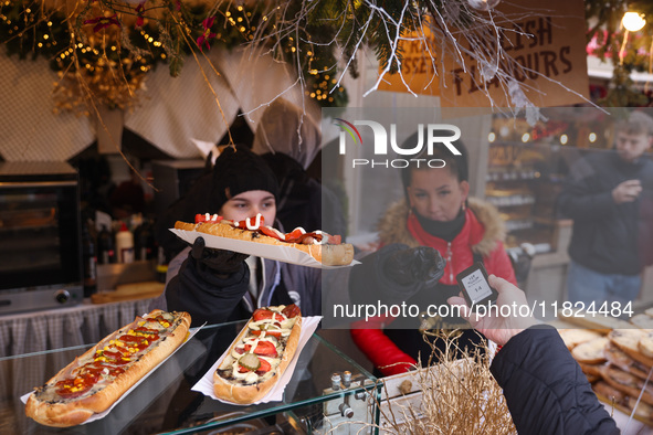 Traditional toasted baguettes with toppings (zapiekanki) are sold at Christmas market at the Main Square in Krakow, Poland on Nobember 30th,...