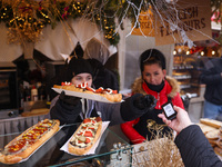 Traditional toasted baguettes with toppings (zapiekanki) are sold at Christmas market at the Main Square in Krakow, Poland on Nobember 30th,...