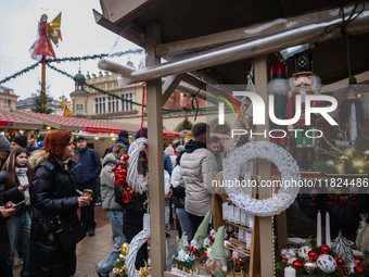 Touriststs visit traditional Christmas market at the Main Square in Krakow, Poland on Nobember 30th, 2024.  (