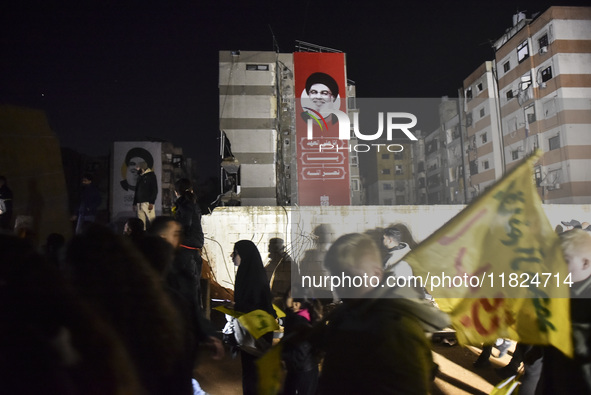 Mourners attend a vigil to honor Hezbollah's late chief Hassan Nasrallah at the site where he was killed in an Israeli air strike in the Har...