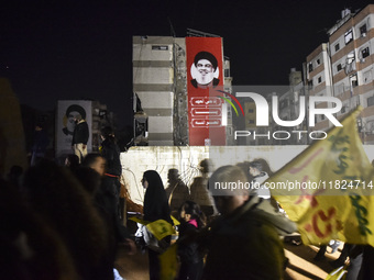 Mourners attend a vigil to honor Hezbollah's late chief Hassan Nasrallah at the site where he was killed in an Israeli air strike in the Har...