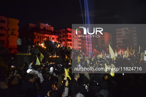 Mourners attend a vigil to honor Hezbollah's late chief Hassan Nasrallah at the site where he was killed in an Israeli air strike in the Har...