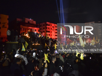 Mourners attend a vigil to honor Hezbollah's late chief Hassan Nasrallah at the site where he was killed in an Israeli air strike in the Har...