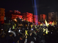 Mourners attend a vigil to honor Hezbollah's late chief Hassan Nasrallah at the site where he was killed in an Israeli air strike in the Har...