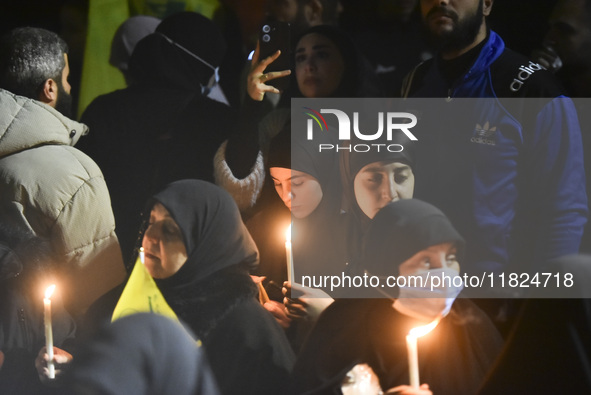 Mourners attend a vigil to honor Hezbollah's late chief Hassan Nasrallah at the site where he was killed in an Israeli air strike in the Har...