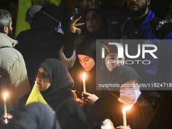 Mourners attend a vigil to honor Hezbollah's late chief Hassan Nasrallah at the site where he was killed in an Israeli air strike in the Har...