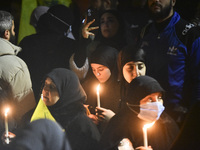 Mourners attend a vigil to honor Hezbollah's late chief Hassan Nasrallah at the site where he was killed in an Israeli air strike in the Har...