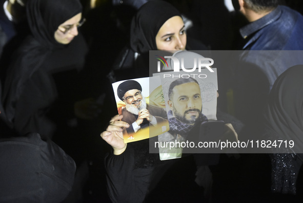 Mourners attend a vigil to honor Hezbollah's late chief Hassan Nasrallah at the site where he was killed in an Israeli air strike in the Har...