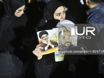 Mourners attend a vigil to honor Hezbollah's late chief Hassan Nasrallah at the site where he was killed in an Israeli air strike in the Har...