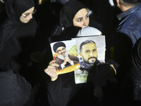 Mourners attend a vigil to honor Hezbollah's late chief Hassan Nasrallah at the site where he was killed in an Israeli air strike in the Har...