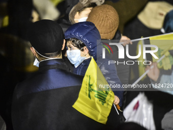 Mourners attend a vigil to honor Hezbollah's late chief Hassan Nasrallah at the site where he was killed in an Israeli air strike in the Har...