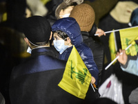 Mourners attend a vigil to honor Hezbollah's late chief Hassan Nasrallah at the site where he was killed in an Israeli air strike in the Har...