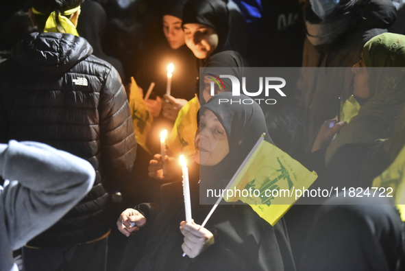 Mourners attend a vigil to honor Hezbollah's late chief Hassan Nasrallah at the site where he was killed in an Israeli air strike in the Har...