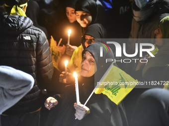 Mourners attend a vigil to honor Hezbollah's late chief Hassan Nasrallah at the site where he was killed in an Israeli air strike in the Har...