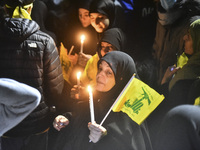 Mourners attend a vigil to honor Hezbollah's late chief Hassan Nasrallah at the site where he was killed in an Israeli air strike in the Har...