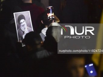 Mourners attend a vigil to honor Hezbollah's late chief Hassan Nasrallah at the site where he was killed in an Israeli air strike in the Har...