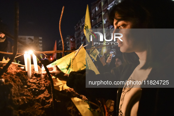 Mourners attend a vigil to honor Hezbollah's late chief Hassan Nasrallah at the site where he was killed in an Israeli air strike in the Har...