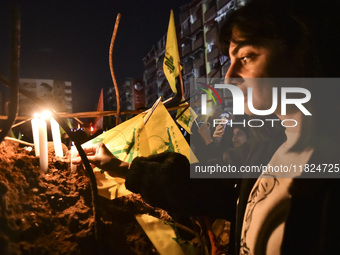 Mourners attend a vigil to honor Hezbollah's late chief Hassan Nasrallah at the site where he was killed in an Israeli air strike in the Har...