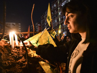 Mourners attend a vigil to honor Hezbollah's late chief Hassan Nasrallah at the site where he was killed in an Israeli air strike in the Har...