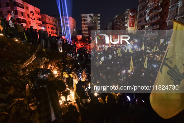 Mourners attend a vigil to honor Hezbollah's late chief Hassan Nasrallah at the site where he was killed in an Israeli air strike in the Har...