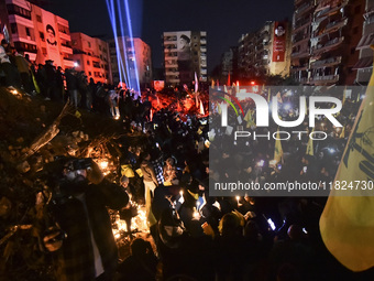 Mourners attend a vigil to honor Hezbollah's late chief Hassan Nasrallah at the site where he was killed in an Israeli air strike in the Har...