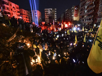 Mourners attend a vigil to honor Hezbollah's late chief Hassan Nasrallah at the site where he was killed in an Israeli air strike in the Har...