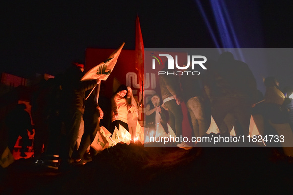 Mourners attend a vigil to honor Hezbollah's late chief Hassan Nasrallah at the site where he was killed in an Israeli air strike in the Har...