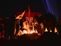 Mourners attend a vigil to honor Hezbollah's late chief Hassan Nasrallah at the site where he was killed in an Israeli air strike in the Har...