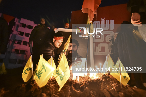 Mourners attend a vigil to honor Hezbollah's late chief Hassan Nasrallah at the site where he was killed in an Israeli air strike in the Har...