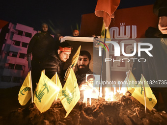 Mourners attend a vigil to honor Hezbollah's late chief Hassan Nasrallah at the site where he was killed in an Israeli air strike in the Har...