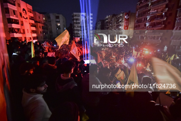 Mourners attend a vigil to honor Hezbollah's late chief Hassan Nasrallah at the site where he was killed in an Israeli air strike in the Har...