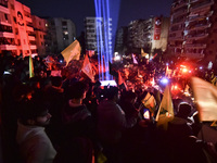 Mourners attend a vigil to honor Hezbollah's late chief Hassan Nasrallah at the site where he was killed in an Israeli air strike in the Har...