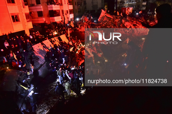 Mourners attend a vigil to honor Hezbollah's late chief Hassan Nasrallah at the site where he was killed in an Israeli air strike in the Har...