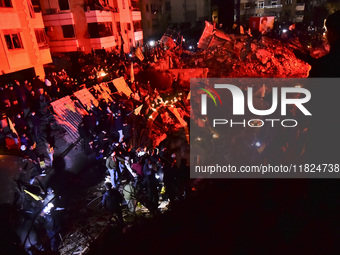 Mourners attend a vigil to honor Hezbollah's late chief Hassan Nasrallah at the site where he was killed in an Israeli air strike in the Har...