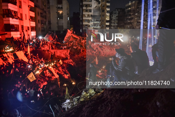 Mourners attend a vigil to honor Hezbollah's late chief Hassan Nasrallah at the site where he was killed in an Israeli air strike in the Har...