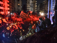 Mourners attend a vigil to honor Hezbollah's late chief Hassan Nasrallah at the site where he was killed in an Israeli air strike in the Har...