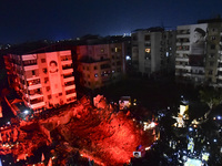 Mourners attend a vigil to honor Hezbollah's late chief Hassan Nasrallah at the site where he was killed in an Israeli air strike in the Har...