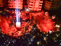 Mourners attend a vigil to honor Hezbollah's late chief Hassan Nasrallah at the site where he was killed in an Israeli air strike in the Har...