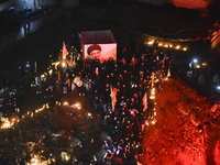 Mourners attend a vigil to honor Hezbollah's late chief Hassan Nasrallah at the site where he was killed in an Israeli air strike in the Har...