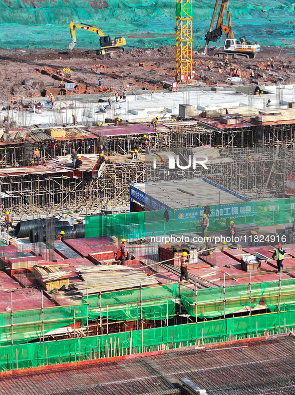 Workers speed up the construction of basic works at the construction site of the urban village renovation project in Chongqing, China, on No...