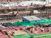 Workers speed up the construction of basic works at the construction site of the urban village renovation project in Chongqing, China, on No...