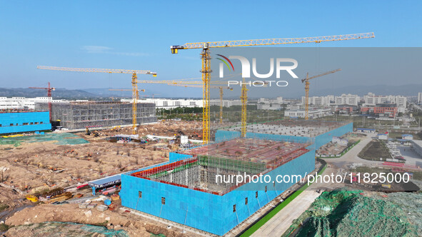 Workers speed up the construction of basic works at the construction site of the urban village renovation project in Chongqing, China, on No...