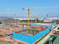 Workers speed up the construction of basic works at the construction site of the urban village renovation project in Chongqing, China, on No...