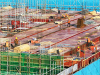 Workers speed up the construction of basic works at the construction site of the urban village renovation project in Chongqing, China, on No...