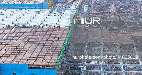 Workers speed up the construction of basic works at the construction site of the urban village renovation project in Chongqing, China, on No...