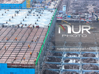 Workers speed up the construction of basic works at the construction site of the urban village renovation project in Chongqing, China, on No...